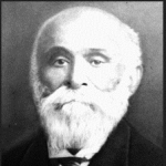 Black & white portrait of older male in suit with full white beard