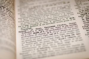 Dictionary page blurred text except for word focus