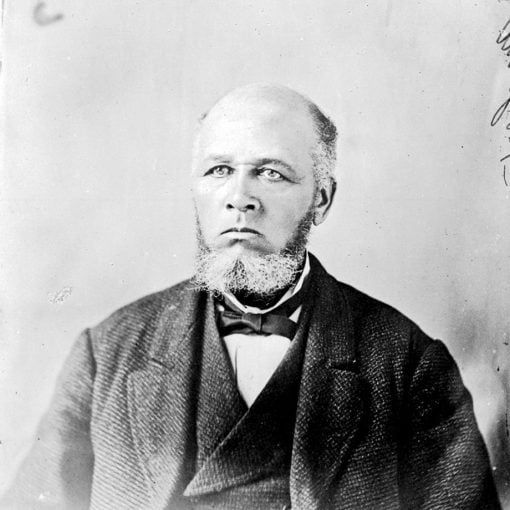 b&w portrait, older man, balding with salt & pepper short beard and sideburns, dressed in suit with vest, white shirt and bowtie