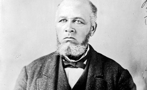 b&w portrait, older man, balding with salt & pepper short beard and sideburns, dressed in suit with vest, white shirt and bowtie