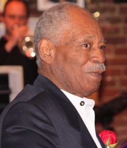 Portrait of senior man in formal wear with carnation in lapel