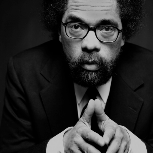 b&w portrait, black man wearing glasses, suit and tie looking directly at camera, hands together in front