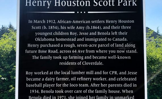 Historical plaque on post white lettering on black background