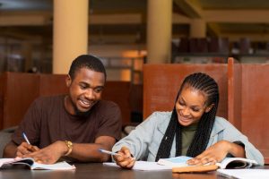 female and male student in library