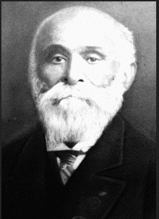 Black & white portrait of older male in suit with full white beard