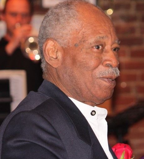 Portrait of senior man in formal wear with carnation in lapel