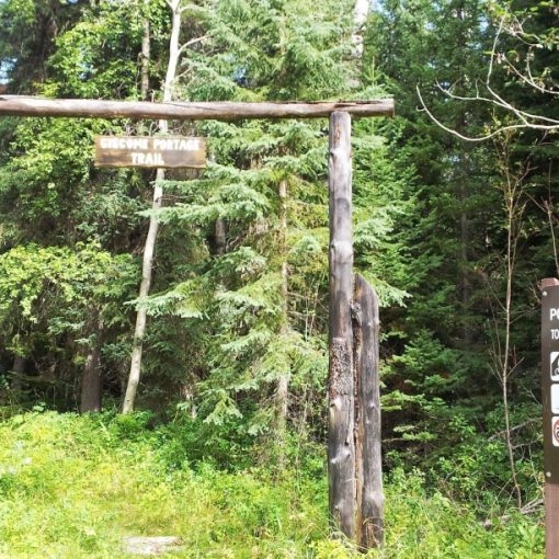 Giscome Portage Trail sign hanging from timber arch