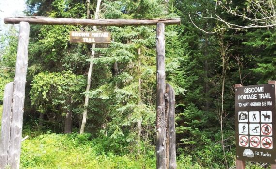 Giscome Portage Trail sign hanging from timber arch