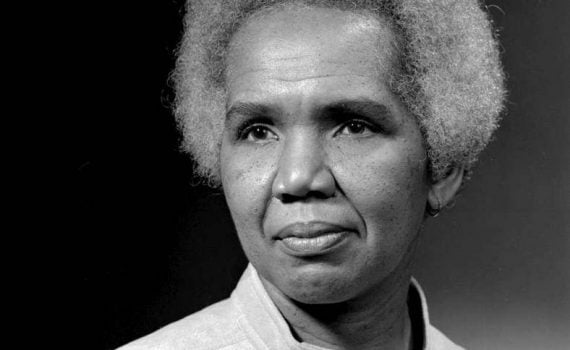 b&w portrait woman with afro hairstyle, gray light button collar top