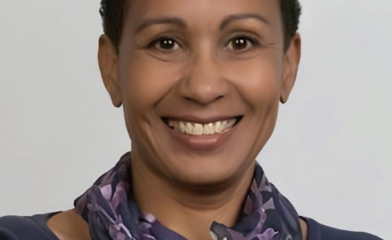portrait of black woman with short hair, dark un-collared dress with scarf