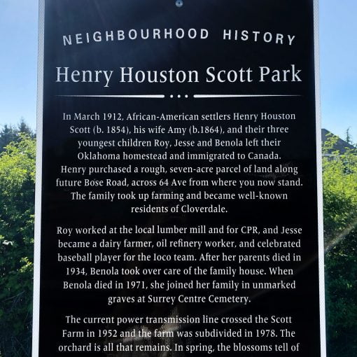 Historical plaque on post white lettering on black background