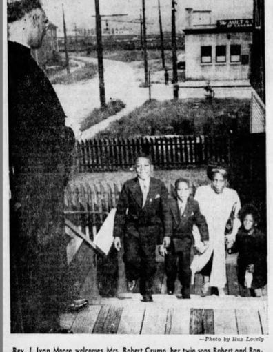 b&w newspaper photo-family walking up front steps of churchtering church